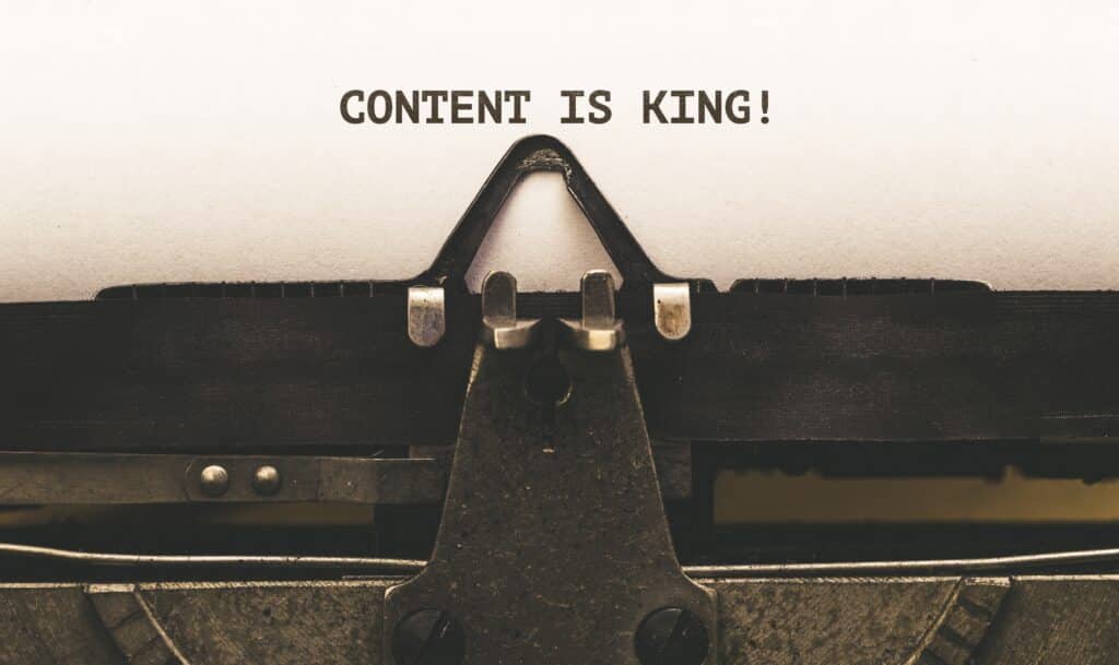 1920s keyboard with the words "Content Is King" - Did you know that there's an irreplaceable synergy between SEO and website design? Learn how website structure, page speed, mobile responsiveness, content quality, and security affect your online visibility and how you can leverage them for your business's digital success. - your wp guy - How can search engine optimization (SEO) be integrated into website design?